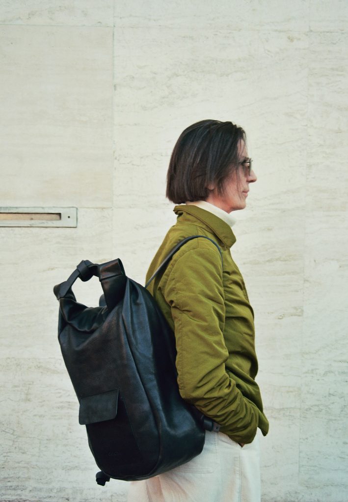 Woman with big black leather backpack